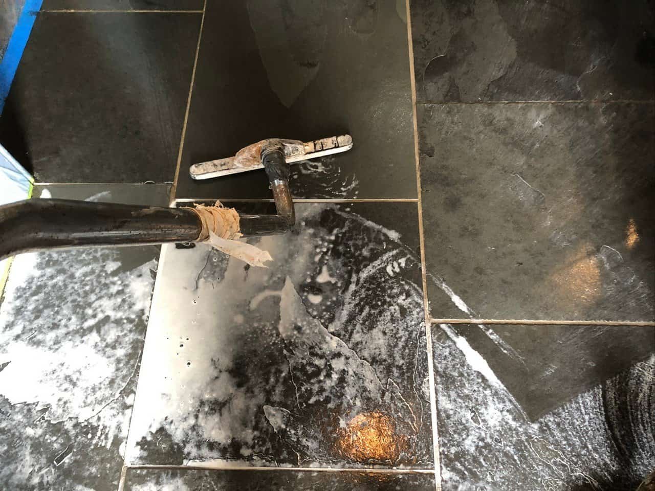 Slate floor being deep cleaned to remove embedded dirt from the surface